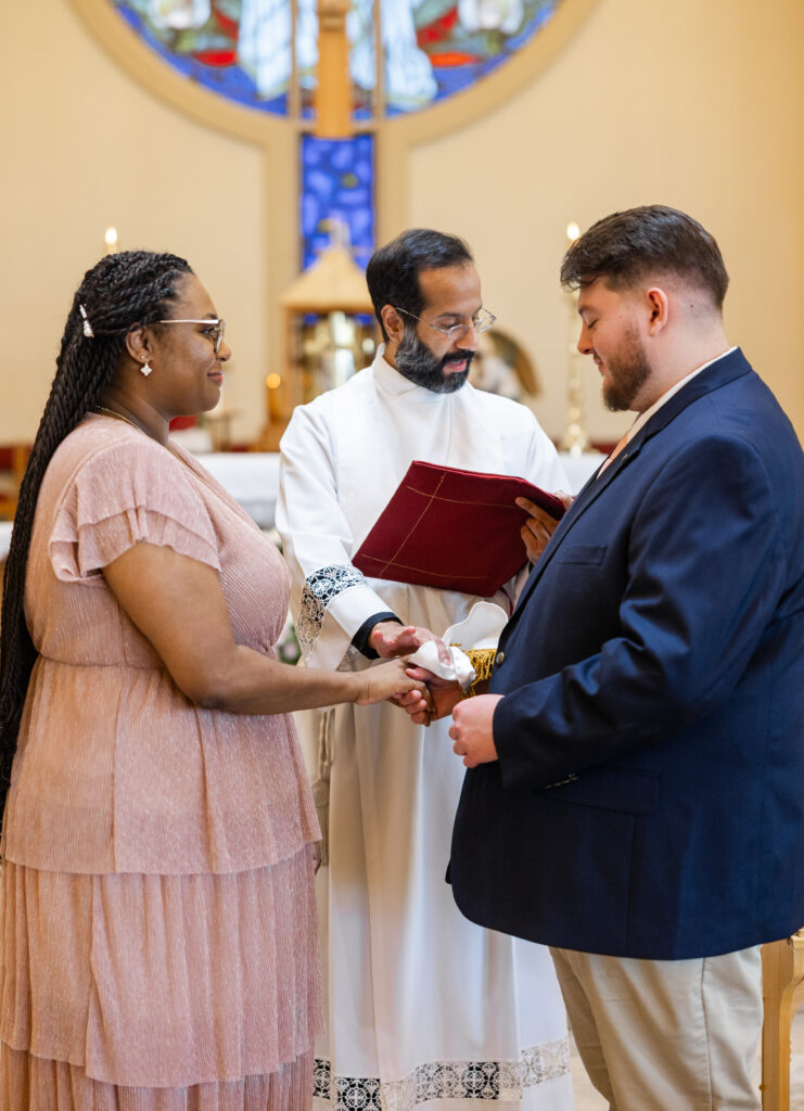 A Catholic couple in the midst of a betrothal ceremony at St. Catherine of Siena in Kennesaw, GA