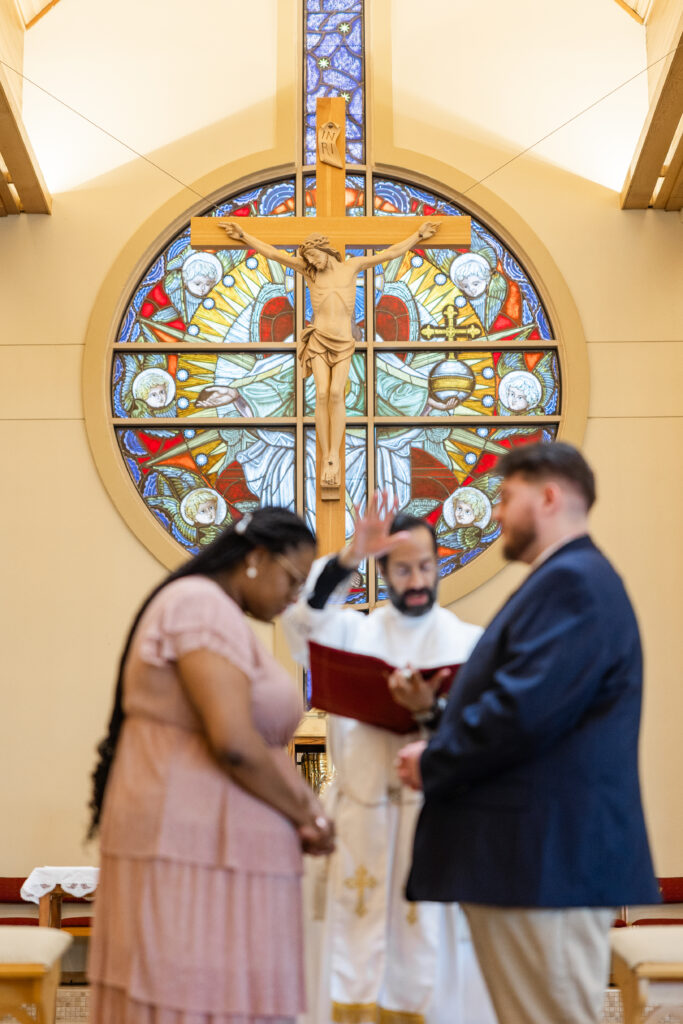 A Catholic couple in the midst of a betrothal ceremony at St. Catherine of Siena in Kennesaw, GA