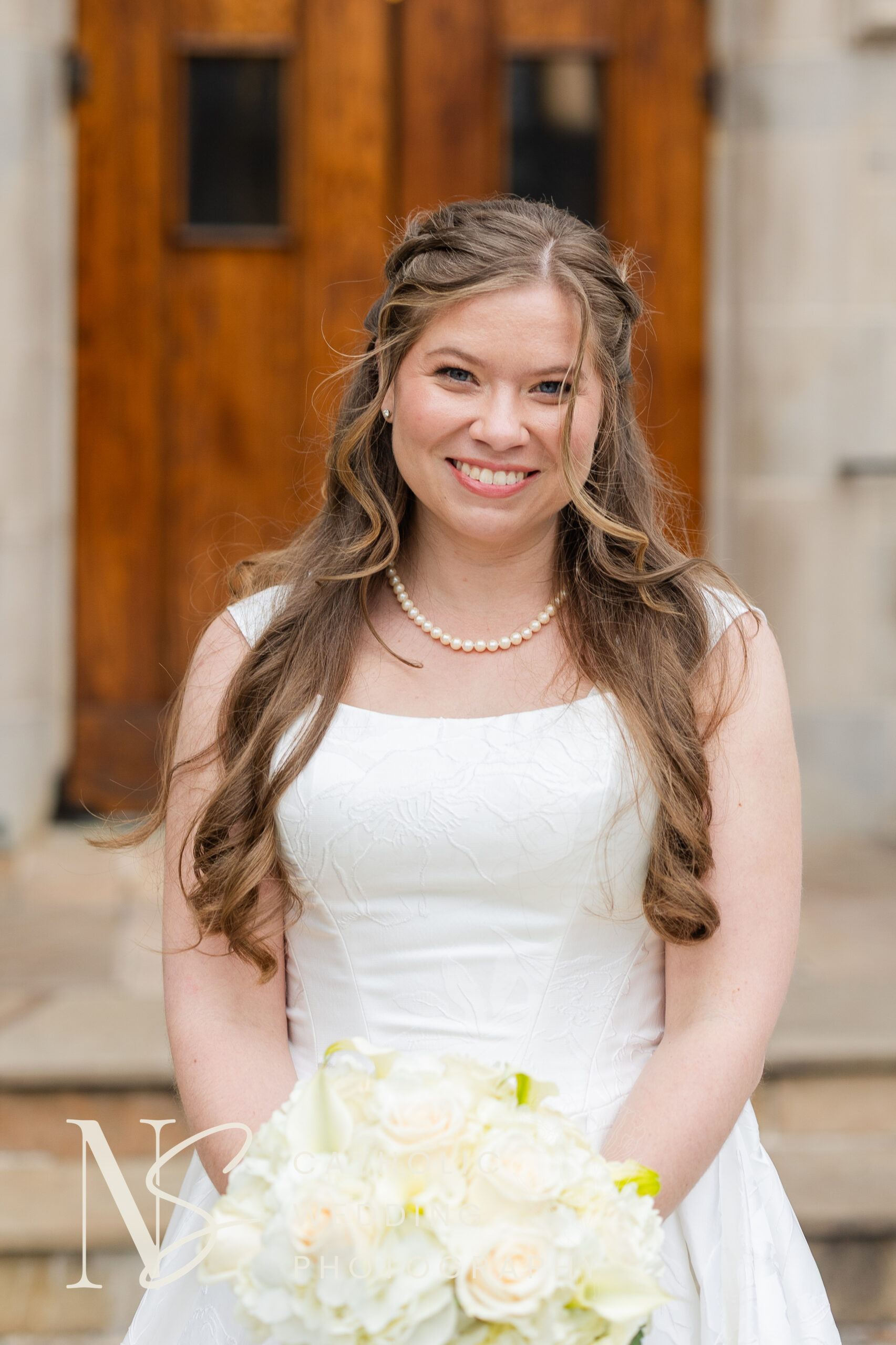 Catholic bride smiling at camera