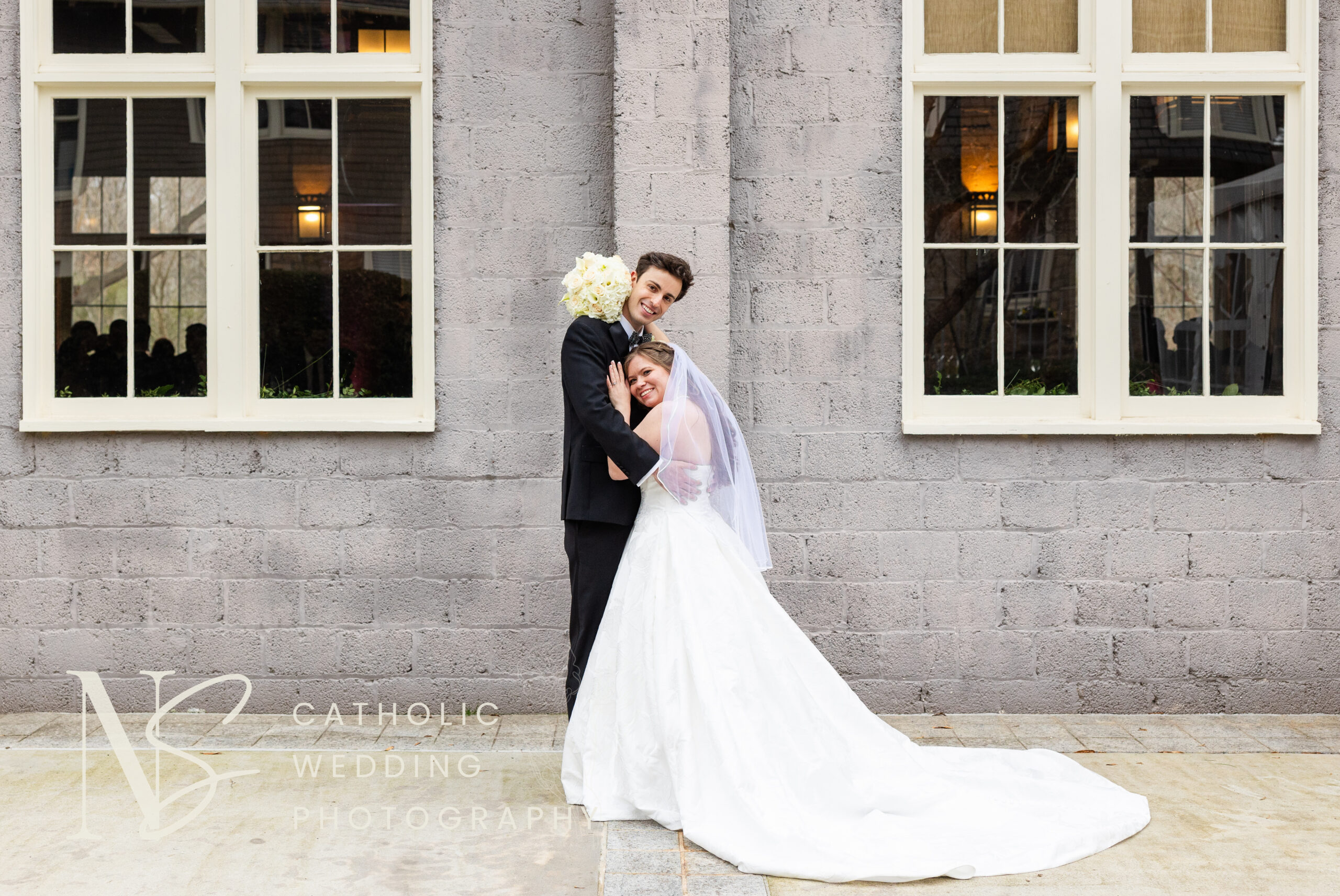 Wedding couple smiles at camera outside Magnolia Hall in Atlanta